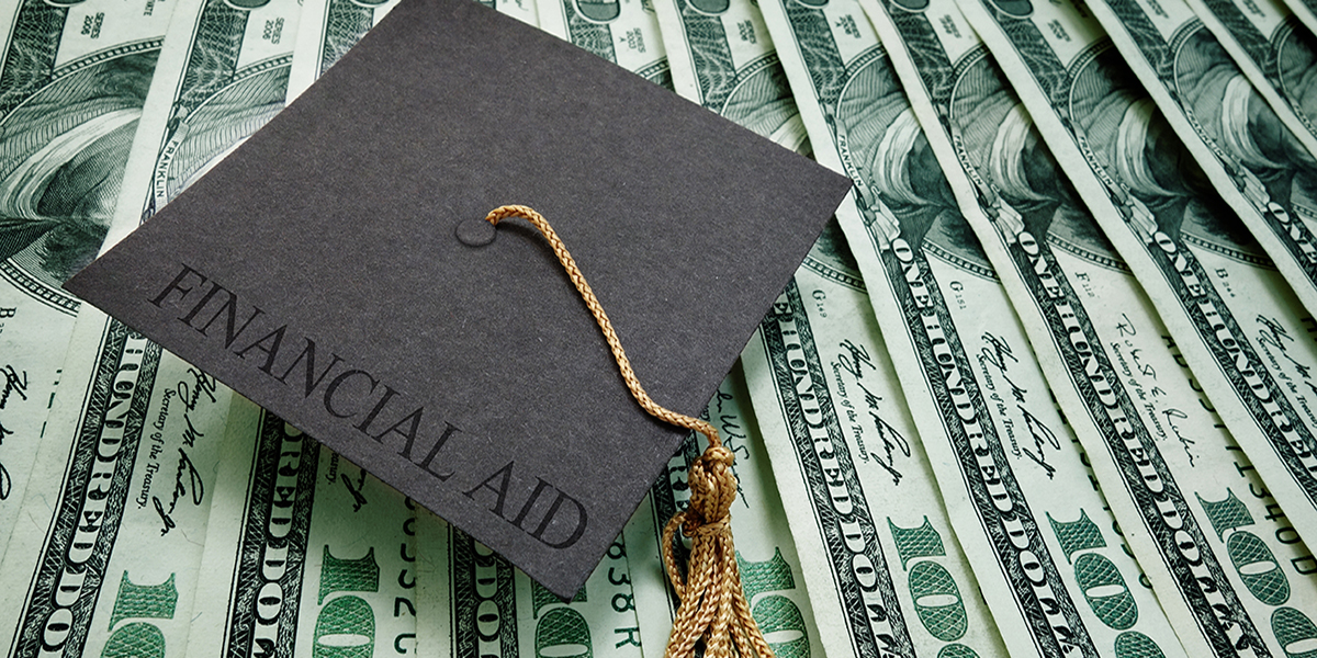 Graduation cap on pile of money | College Aid Services Graduation cap on pile of money